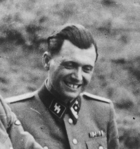 Josef Mengele. A middle-aged man in a German SS uniform, smiling.