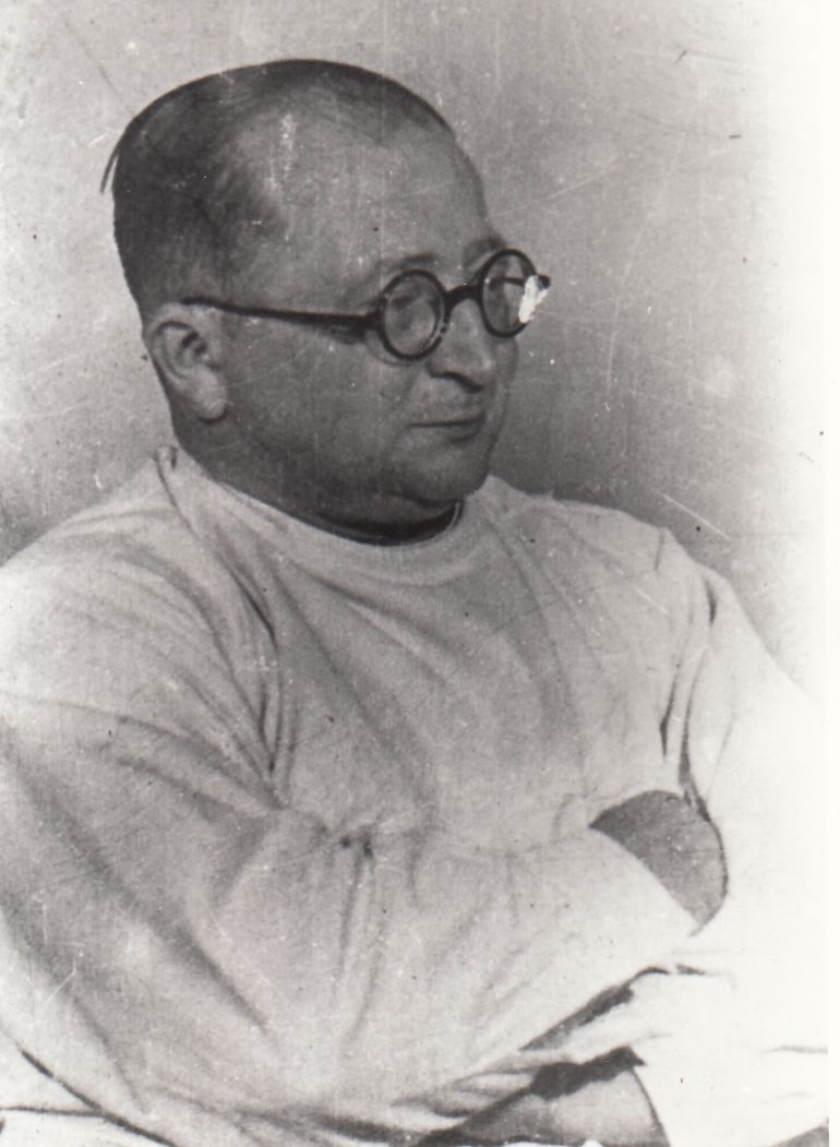 A photographic portrait of Dr. Carl Clauberg in a white medical coat and glasses.