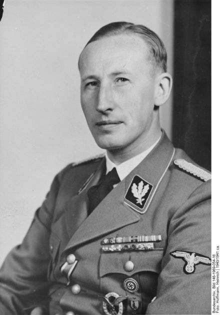 Man in German uniform. Gaze directed towards the lens, face focused with serious expression.