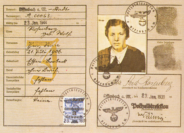 The passport of Sarah Rosenberg. In the photograph is a young woman with dark hair, wearing a white blouse with a collar and a jacket. On the passport are the stamps of the Third Reich - an eagle holding a wreath with a swastika in its talons and a large letter 'J'.