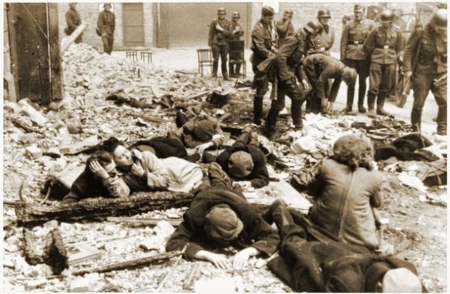 A group of young people, men and women, lying on the ruins, German soldiers in uniforms behind them. 