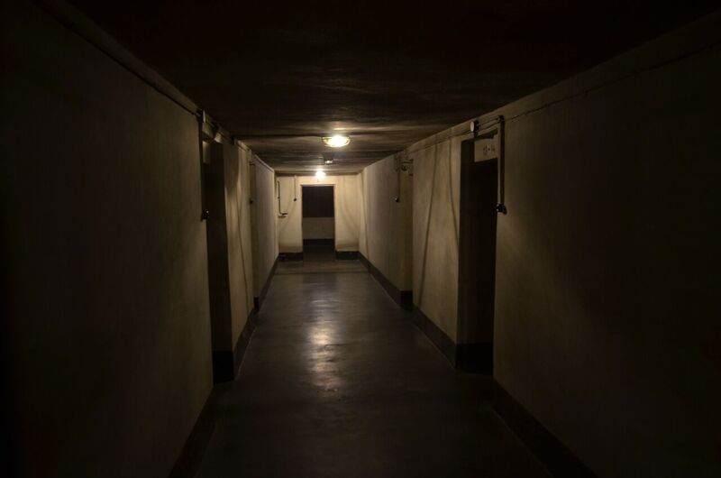 Underground corridor of block 11. On two sides and at the end of the corridor entrances leading to the cells.