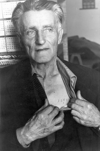 Former Soviet prisoner of war Franciszek Gut-Biernat opens his shirt and shows the number tattooed on the left side of his chest.