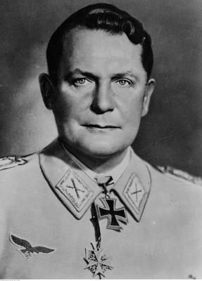 Portrait photograph of a man wearing a light-coloured German uniform. At the collar of the uniform two medals. Gaze to the side. Focused, serious expression.