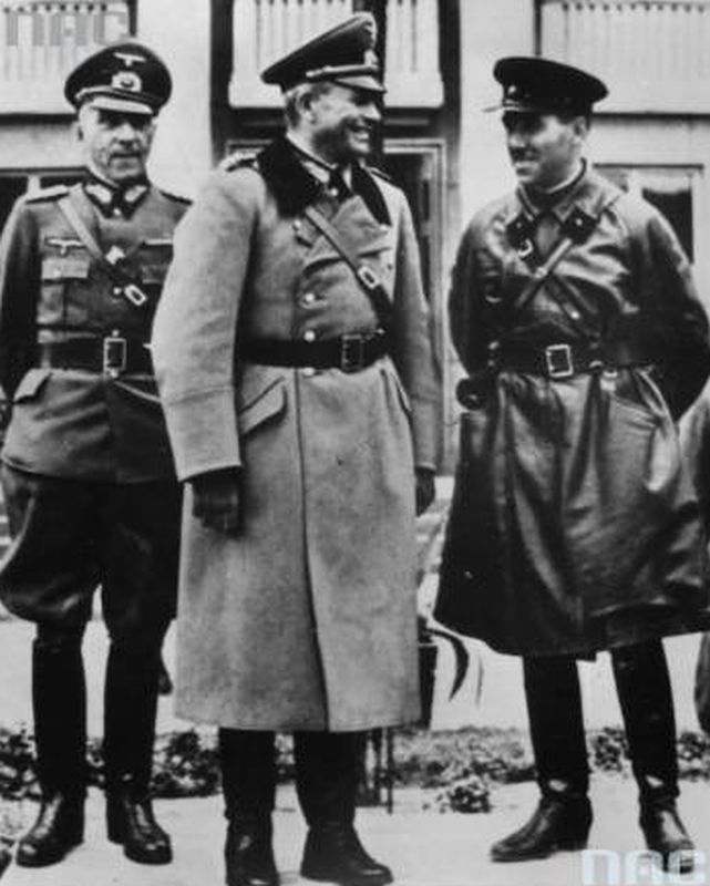 Three smiling man in German uniforms.
