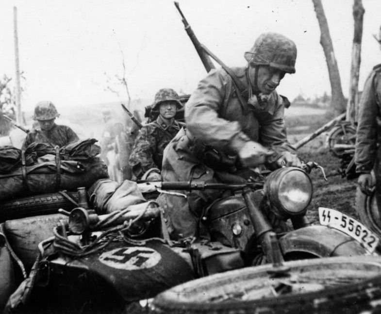 German soldiers in cars and on motorbikes.