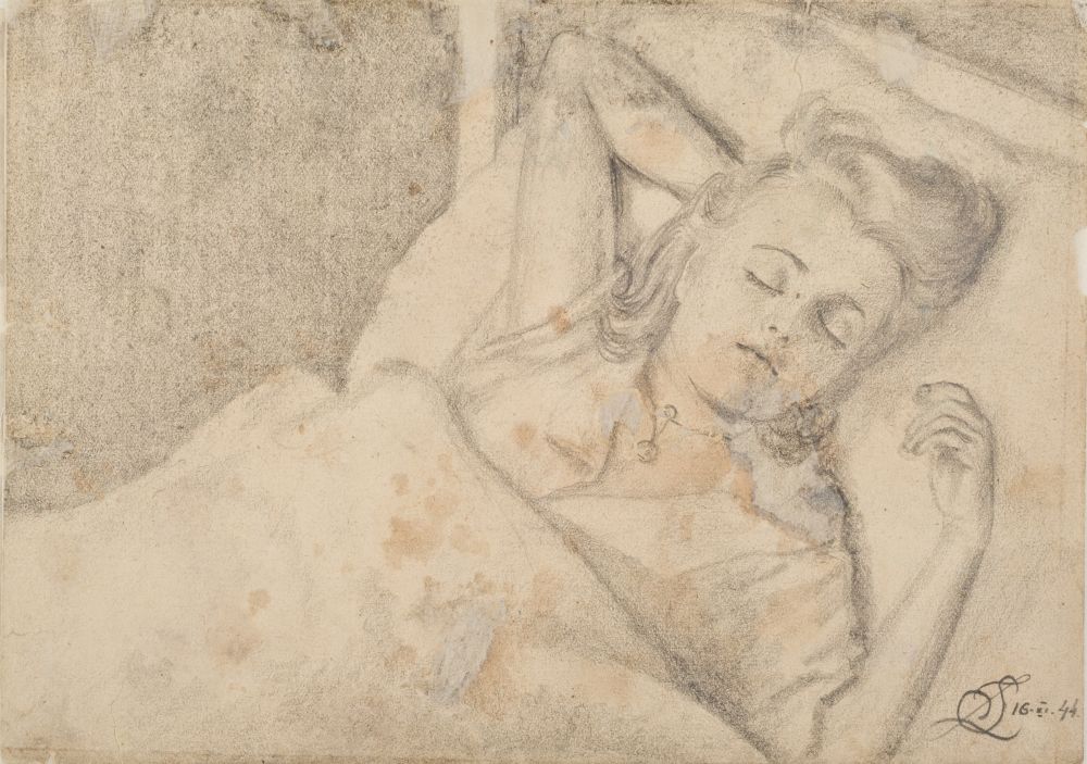 A young woman lying in bed and sleeping.  Her hands are lying freely around her head. A pendant around her neck. Covered with a duvet.