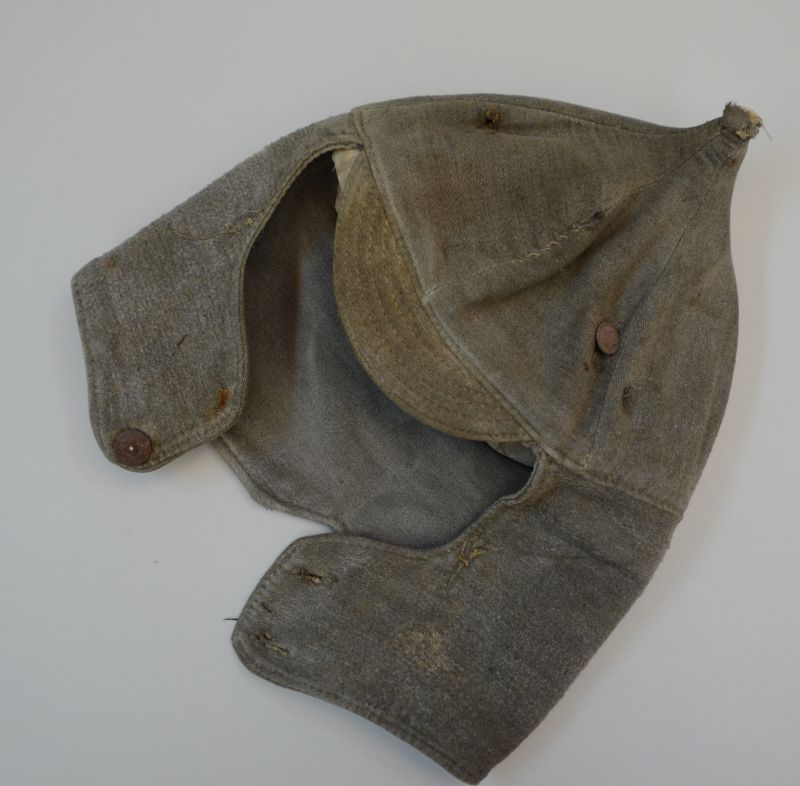 Old, tattered cap – earflap cap.