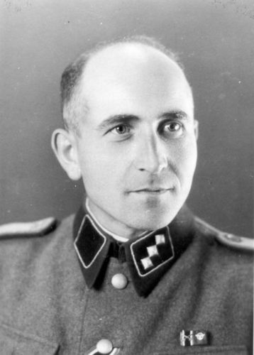 Maximilian Grabner 
A middle-aged man in a German SS uniform, remains serious. Glancing at the side of the camera.