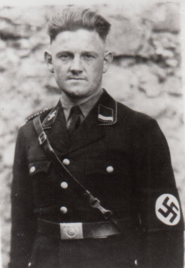 SS-Hauptsturmführer Franz Hössler wearing a German uniform with a swastika on his arm.